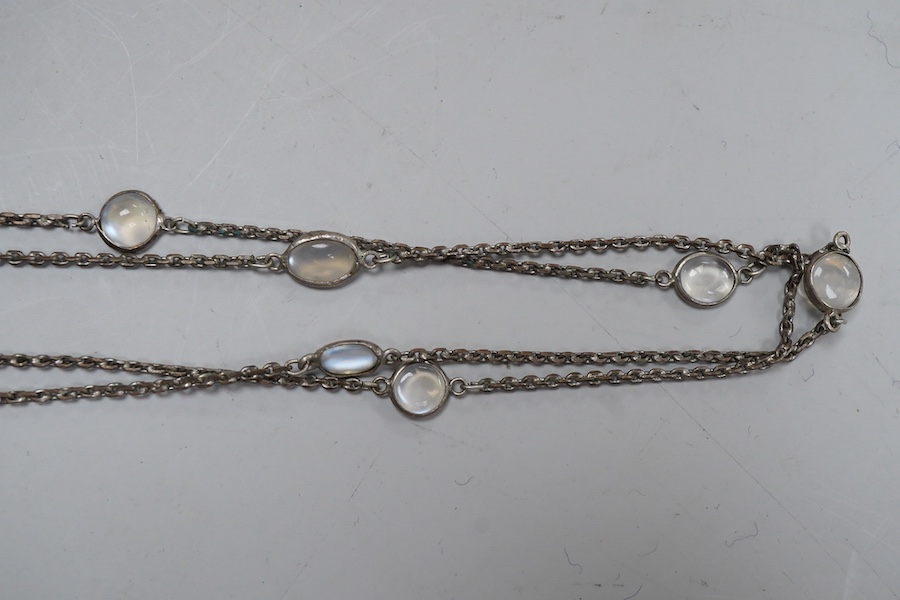A silver and moonstone longchain necklace, set with cabochon moonstones, connected by a fine link chain, length 128cm, Condition: overall good condition, attractive moonstones and nice design. Silver with typical tarnish